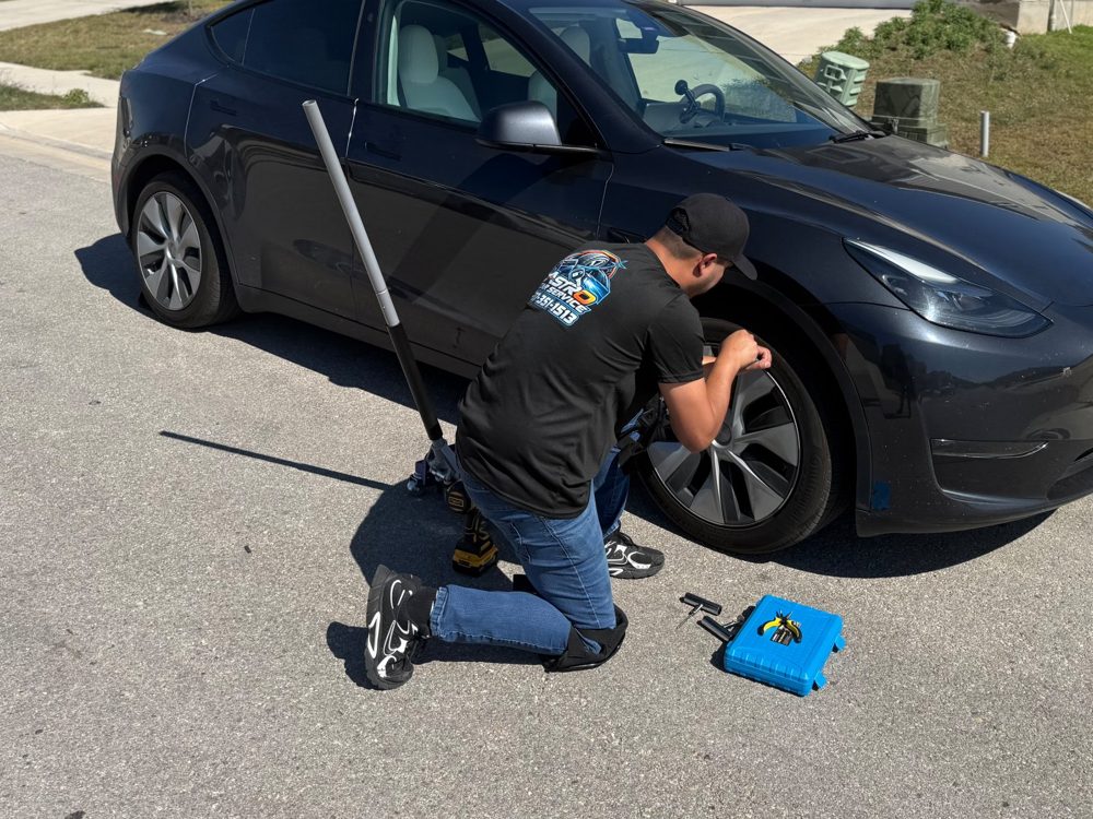 Technician repairing a flat tire on site